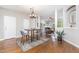 Inviting dining area with hardwood floors, chandelier, and view into the living room at 100 Stratford Lakes # 130, Durham, NC 27713