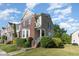 View of a two-story townhome showcasing well-maintained landscaping and architectural details at 100 Stratford Lakes # 130, Durham, NC 27713