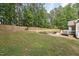 Expansive backyard with a wooden fence, manicured lawn, and patio at 105 Old Barn Way, Wendell, NC 27591