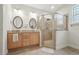 Bright bathroom featuring a double vanity and a walk-in shower with glass doors at 105 Old Barn Way, Wendell, NC 27591