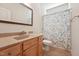 Cozy bathroom with a granite-look sink top, toilet, and tub with a floral curtain at 105 Old Barn Way, Wendell, NC 27591
