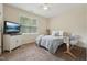 Bedroom with a large window and a ceiling fan is furnished with a bed and TV at 105 Old Barn Way, Wendell, NC 27591