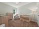 Bedroom bedroom with neutral color scheme, crib, and dresser for a calm space at 105 Old Barn Way, Wendell, NC 27591