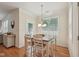 Bright dining area with wood floors, natural light, and view into the kitchen at 105 Old Barn Way, Wendell, NC 27591