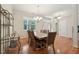 Open dining room with hardwood floors, a chandelier, and large windows at 105 Old Barn Way, Wendell, NC 27591