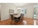 Cozy dining area featuring hardwood floors and natural light from the windows at 105 Old Barn Way, Wendell, NC 27591