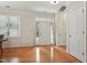 Sun-lit entryway showcasing hardwood floors and a white front door at 105 Old Barn Way, Wendell, NC 27591