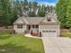 Charming home with a well-manicured lawn, a two-car garage and delightful curb appeal at 105 Old Barn Way, Wendell, NC 27591