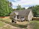 Exterior shot showcasing the home's backyard, deck, and surrounding trees at 105 Old Barn Way, Wendell, NC 27591