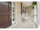 Inviting front porch featuring rocking chairs and a neutral exterior at 105 Old Barn Way, Wendell, NC 27591