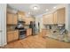Well-equipped kitchen with stainless steel appliances, granite countertops, and light wood cabinetry at 105 Old Barn Way, Wendell, NC 27591
