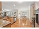 Open-concept kitchen flows into dining area with stainless steel appliances and granite countertops at 105 Old Barn Way, Wendell, NC 27591