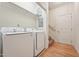 Laundry room with washer, dryer, a shelf, and access to a staircase at 105 Old Barn Way, Wendell, NC 27591