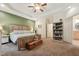 Spacious main bedroom offering a large bed, tray ceilings, natural light, and adjoining bathroom at 105 Old Barn Way, Wendell, NC 27591
