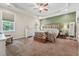 Serene main bedroom featuring a tray ceiling, natural light, and comfortable furnishings at 105 Old Barn Way, Wendell, NC 27591