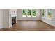 Living room featuring a fireplace, large windows, and wood floors, providing ample natural light and warmth at 109 Bronco Pace Dr, Clayton, NC 27520