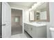 Bathroom with double vanity, marble countertops, and tile floors at 1110 Elmira Ave, Durham, NC 27707