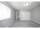 A neutral bedroom with carpet, a closet and a large window that provides a bright and airy feel at 1110 Elmira Ave, Durham, NC 27707