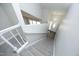 Bright entryway with a staircase, white railing, and modern lighting fixture for a clean and stylish look at 1110 Elmira Ave, Durham, NC 27707