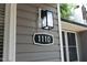 Close-up of house number 1110 with modern lighting fixture at 1110 Elmira Ave, Durham, NC 27707