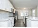 Open concept kitchen with modern stainless steel appliances and a large island at 1110 Elmira Ave, Durham, NC 27707
