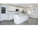 Beautiful white kitchen with stainless steel appliances, island, and modern fixtures at 1110 Elmira Ave, Durham, NC 27707