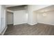 Open-concept living space with wood flooring and modern light fixture at 1110 Elmira Ave, Durham, NC 27707