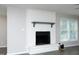 Bright living room featuring a white brick fireplace with dark hearth and a gray mantle at 1110 Elmira Ave, Durham, NC 27707