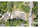 Aerial view of property with outbuildings, greenery and ample parking area at 112 S Joyland St, Durham, NC 27703