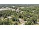 Aerial view showcases residential property surrounded by a vibrant mix of greenery and commercial establishments at 112 S Joyland St, Durham, NC 27703