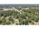 A broad aerial view showcases a neighborhood, capturing the flow of traffic and the dense tree canopy at 112 S Joyland St, Durham, NC 27703