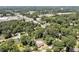 High angle view of residential property with dense trees, nearby street access, and mixed residential and commercial vicinity at 112 S Joyland St, Durham, NC 27703