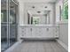 Bright bathroom featuring a double sink vanity with modern fixtures and a glass-enclosed shower at 112 S Joyland St, Durham, NC 27703