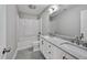 Bathroom with a tub and shower combo, granite countertops and a large mirror at 112 S Joyland St, Durham, NC 27703