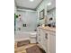 Bathroom showcasing a shower-tub combo, white vanity with sink, and wood-look flooring at 112 S Joyland St, Durham, NC 27703