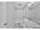 This bathroom features a bathtub with shower, a toilet, and a single sink vanity with grey tile flooring at 112 S Joyland St, Durham, NC 27703