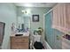 Bathroom featuring a framed mirror, wood vanity, a toilet, and a shower-tub combo with glass door at 112 S Joyland St, Durham, NC 27703