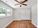 Bedroom with hardwood floors, a ceiling fan and a double door closet for storage at 112 S Joyland St, Durham, NC 27703