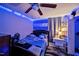 Cozy bedroom featuring ceiling fan, desk and Honduras flag decor, illuminated by ambient blue LED strip lights at 112 S Joyland St, Durham, NC 27703