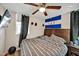 This bedroom includes a window, ceiling fan, and wooden furniture, with a decorative flag hung on the wall at 112 S Joyland St, Durham, NC 27703