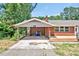A detailed shot of the carport showing the red brick and adjacent porch at 112 S Joyland St, Durham, NC 27703