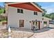 This white house features red trim, stone details, and a concrete front porch with seating at 112 S Joyland St, Durham, NC 27703
