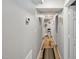 Hallway featuring hardwood floors, neutral paint, and minimalist decor, leads into the home at 112 S Joyland St, Durham, NC 27703