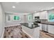 Contemporary kitchen featuring white cabinets, granite counters, stainless steel appliances, and an island at 112 S Joyland St, Durham, NC 27703