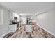 Bright open kitchen with white cabinets, stainless appliances, and a center island for extra prep space at 112 S Joyland St, Durham, NC 27703