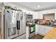 This kitchen includes white cabinets, stainless steel appliances, and neutral countertops and backsplash at 112 S Joyland St, Durham, NC 27703