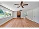 Bright living room with hardwood floors, a fireplace, and an open layout flowing into the kitchen at 112 S Joyland St, Durham, NC 27703