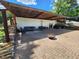 Brick patio featuring comfortable seating, a fire pit, firewood, and partial covering at 112 S Joyland St, Durham, NC 27703
