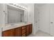 Primary bathroom with dual sink vanity, large mirror, and tile flooring at 1120 Renewal Pl # 111, Raleigh, NC 27603