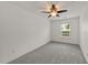 Well-lit bedroom featuring neutral carpeting, ceiling fan, and bright window at 1120 Renewal Pl # 111, Raleigh, NC 27603